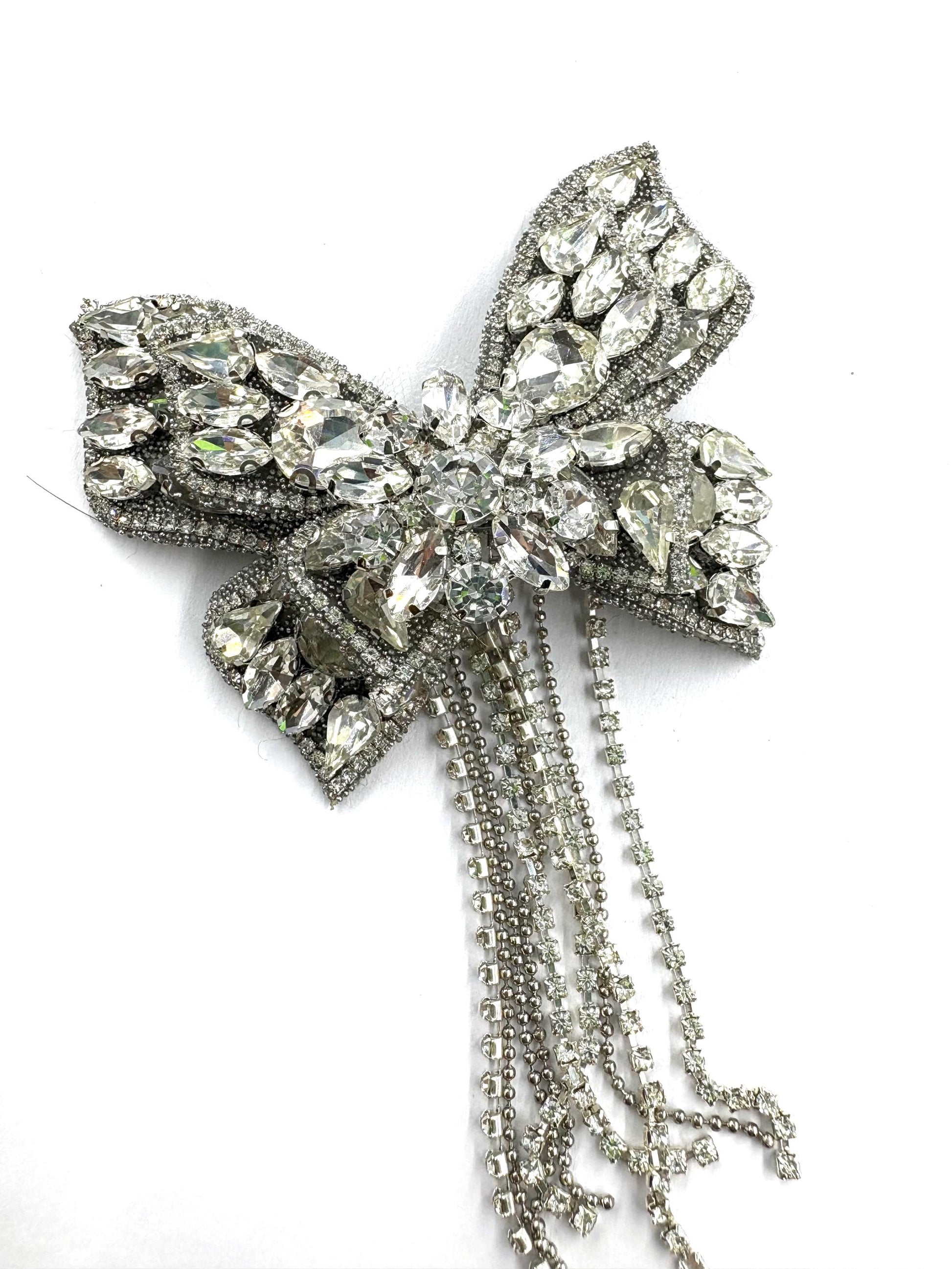Close-up of silver tone rhinestone butterfly embellishment