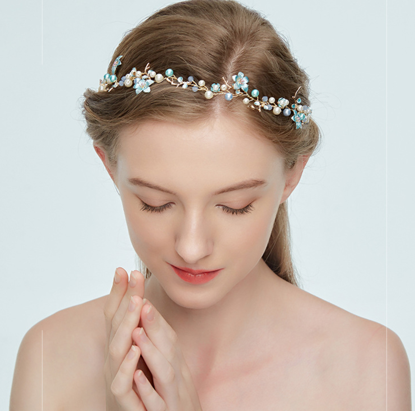Woman wearing a decorative headband with a plain background